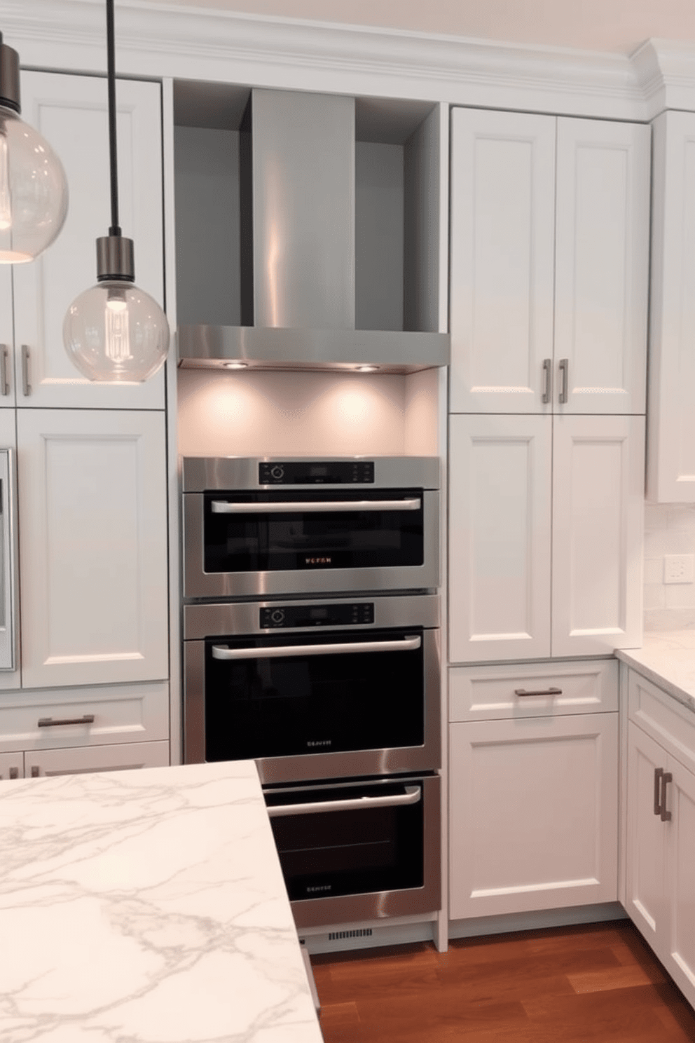 A modern kitchen featuring a double oven stove integrated into a sleek cabinetry design. The stove is surrounded by a spacious countertop with elegant marble finishes, and stylish pendant lights hang above for added ambiance.